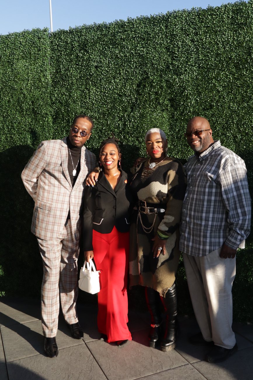 Guests with host Chris The Mayor Thomas in front of the green wall
