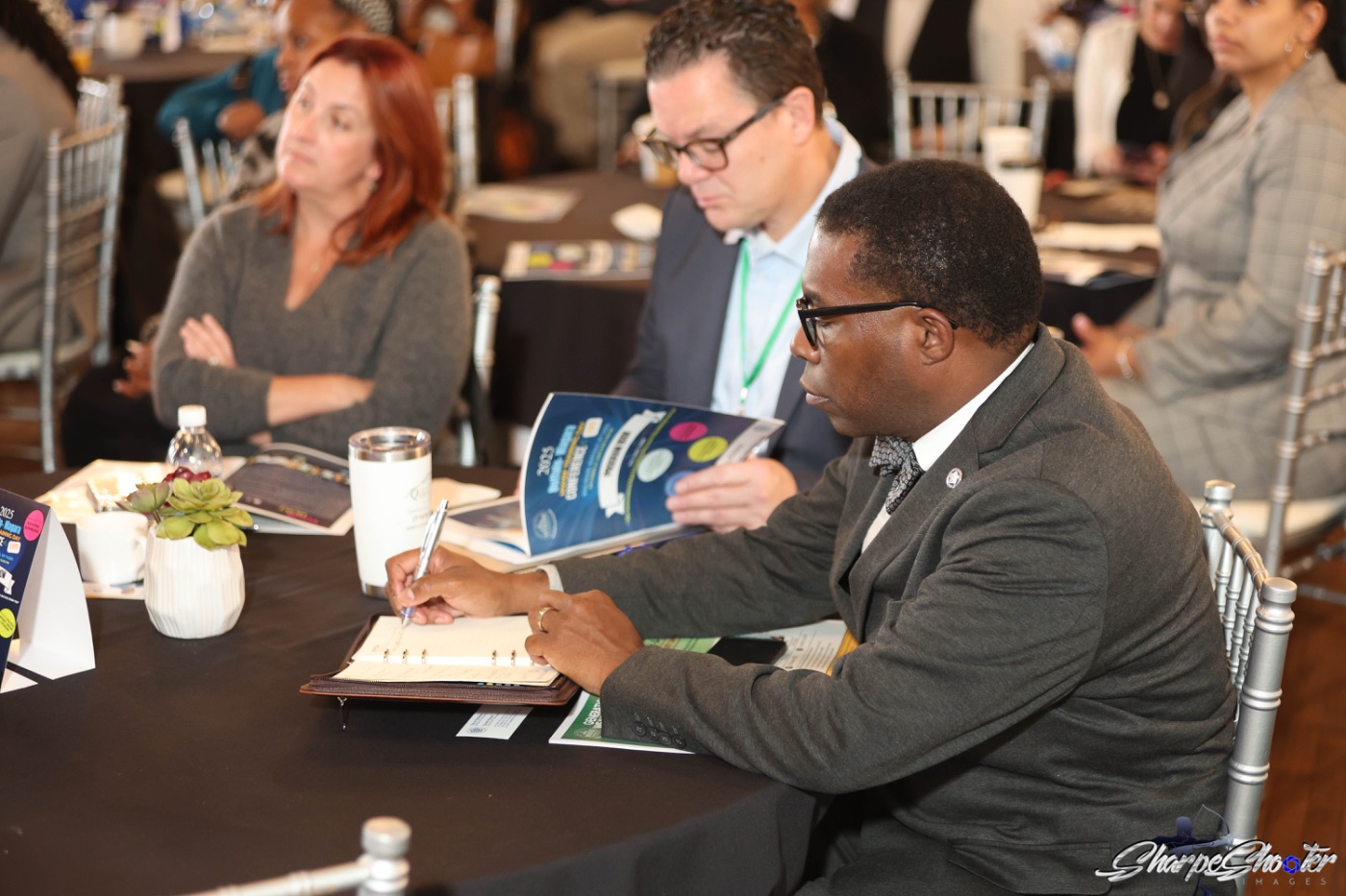 An attendee taking notes during a workshop